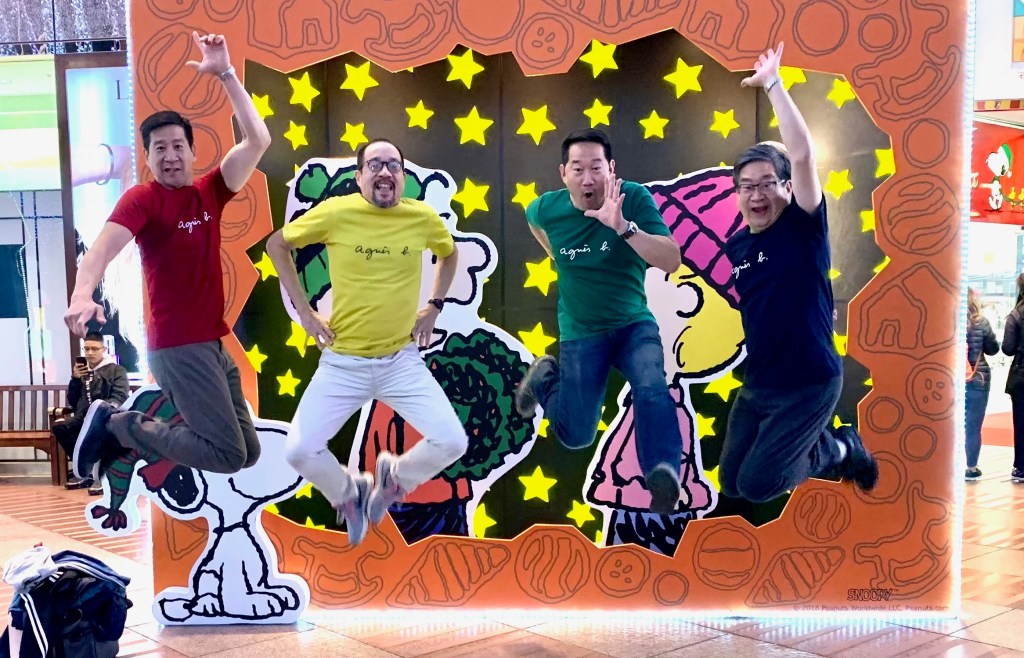 Four jumping brothers wearing shirts in blue, green, yellow, and red