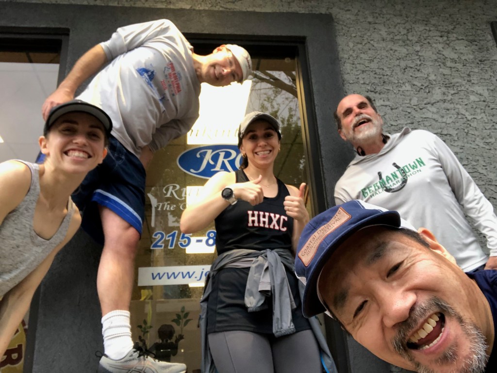 Selfie with runners lined up in front of JRC from low pointing up