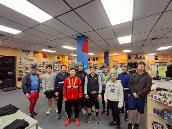 A line of runners across the interior of Jenkintown Running Company