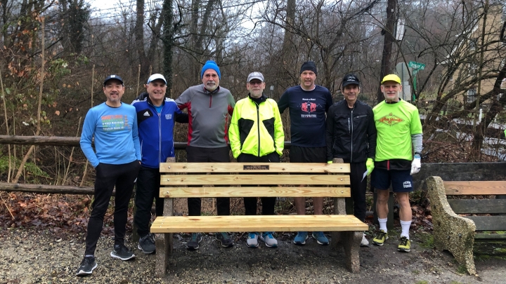 Runners lined up behind ZY Memorial Bench with James in the center