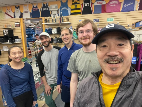 Selfie with runners and stockroom door behind, Keith looking out