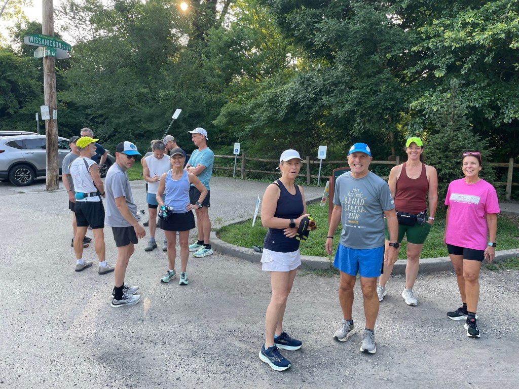 Runners in mild weather running gear arrayed near the Valley Green drinking fountain